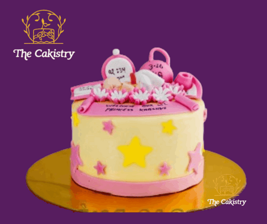 Pink and yellow birthday cake with new born baby, branded 'The Cakistry'.