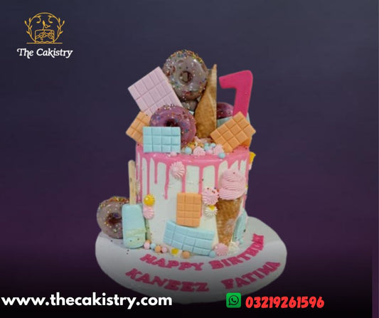 Candyland themed cake decorated with icecream, donuts chocolates from The Cakistry