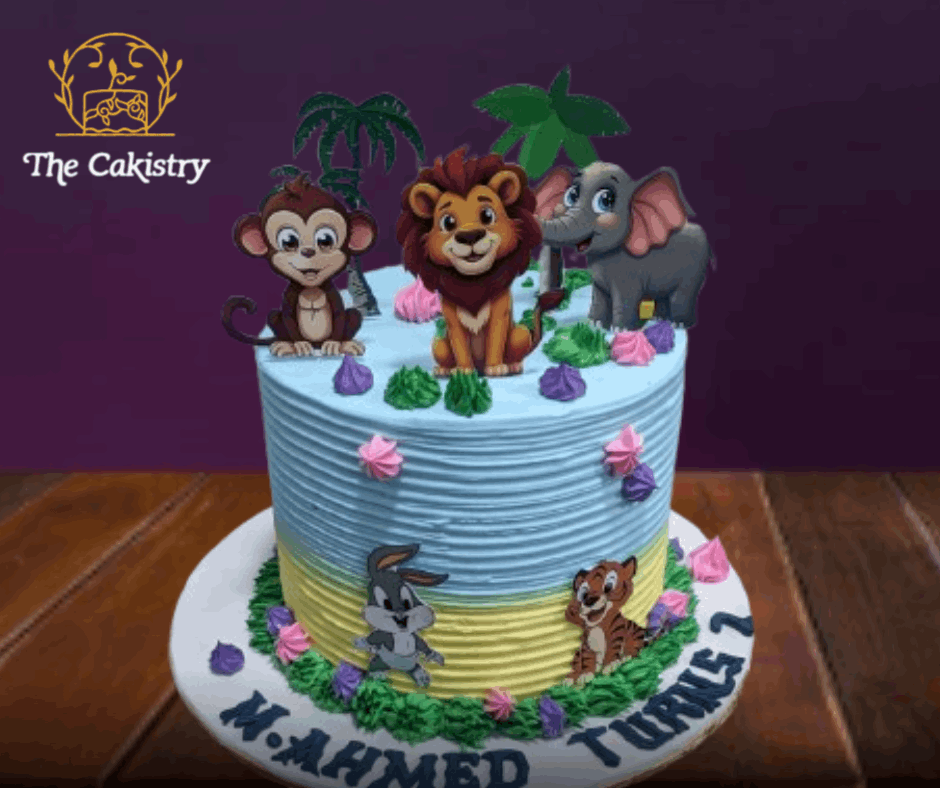 Cake with cartoon animal figures and 'The Cakistry' branding