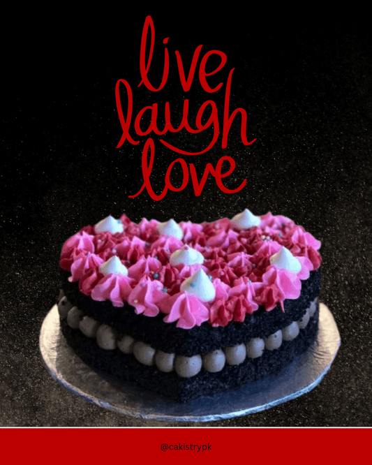 Heart-shaped cake with pink and white frosting on a dark background with 'live laugh love' text.
